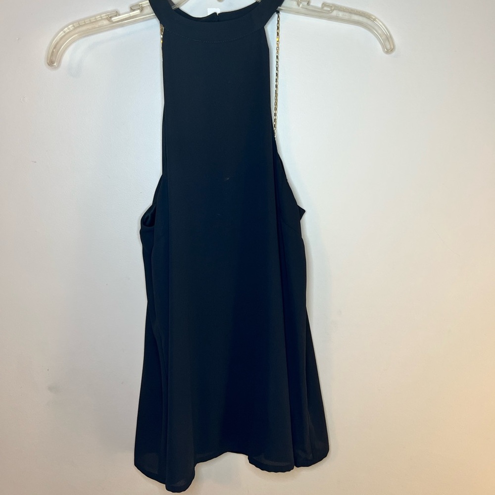black halter top with gold chains in the back